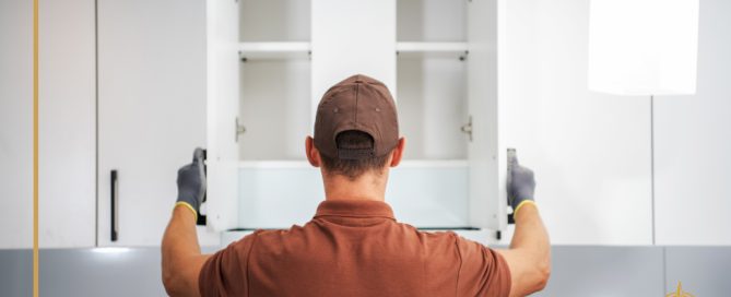 A man installs cabinets in a kitchen. True North Cabinetry stands ready to help you in your projects.