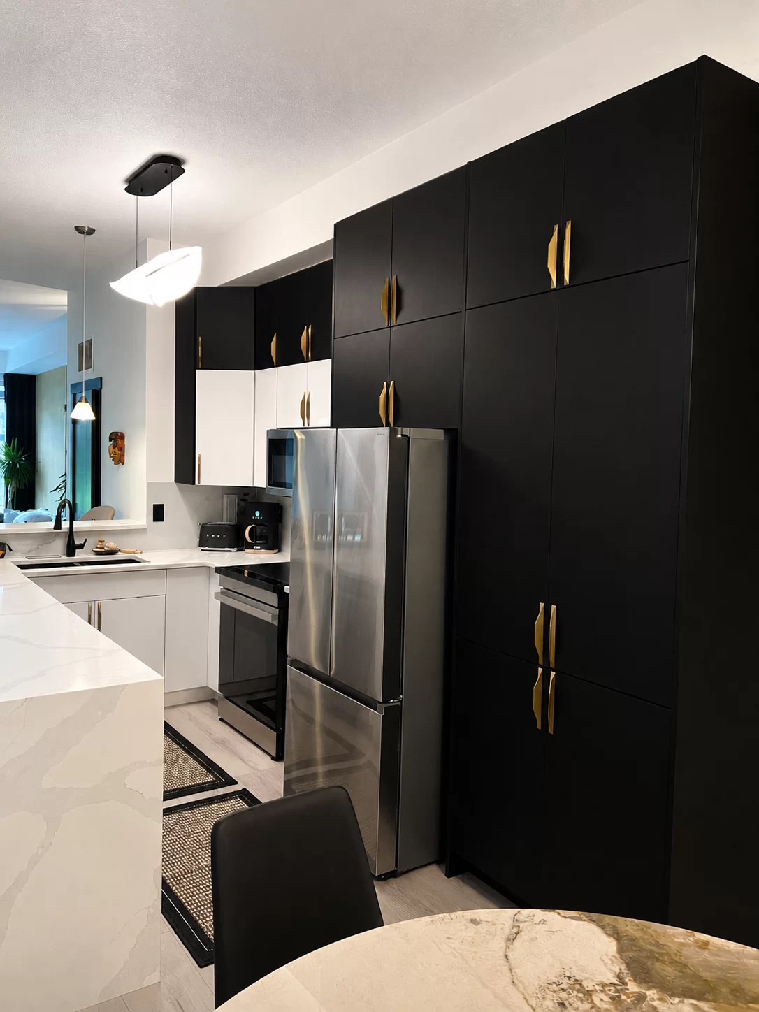 Black custom cabinetry with gold hardware designed and built by True North Cabinetry in Edmonton.